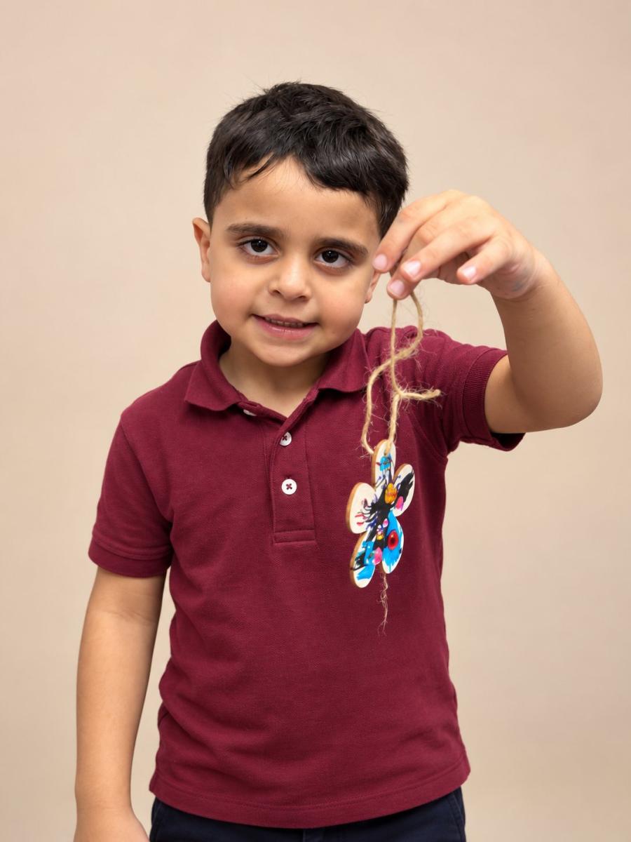 Boy holding his painted flower ornament
